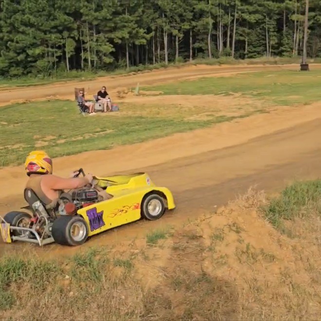 Travis Rainey sliding the yellow 10X kart through the corner during the Box Stock feature at Camden Speedway