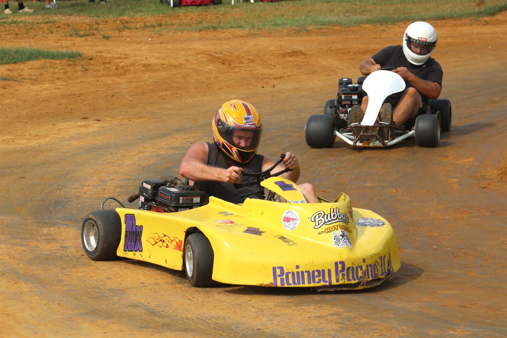 Travis's yellow 10X leading another kart through the corner at Camden Speedway
