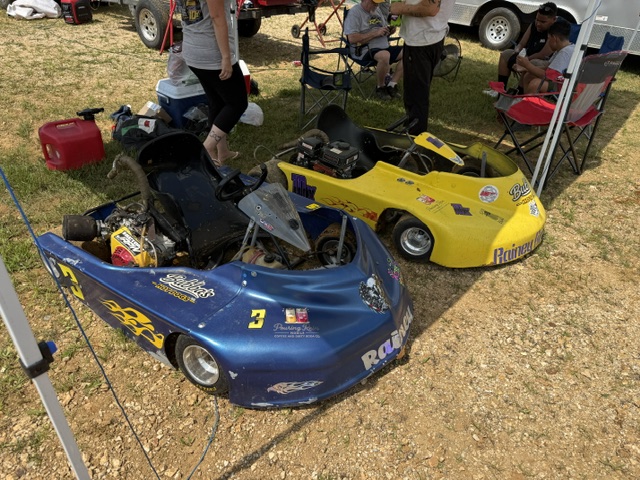 The blue 3 and yellow 10X in the pits with families and haulers in the background